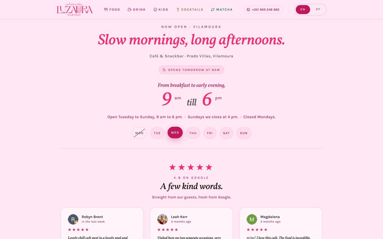 The Luz Aura Café website on a laptop: pink, with today’s opening hours and Google reviews.